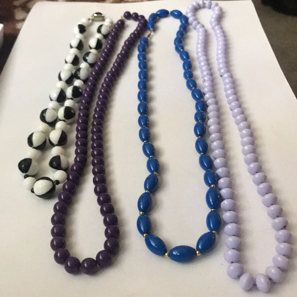 4 long costume jewelry necklaces.